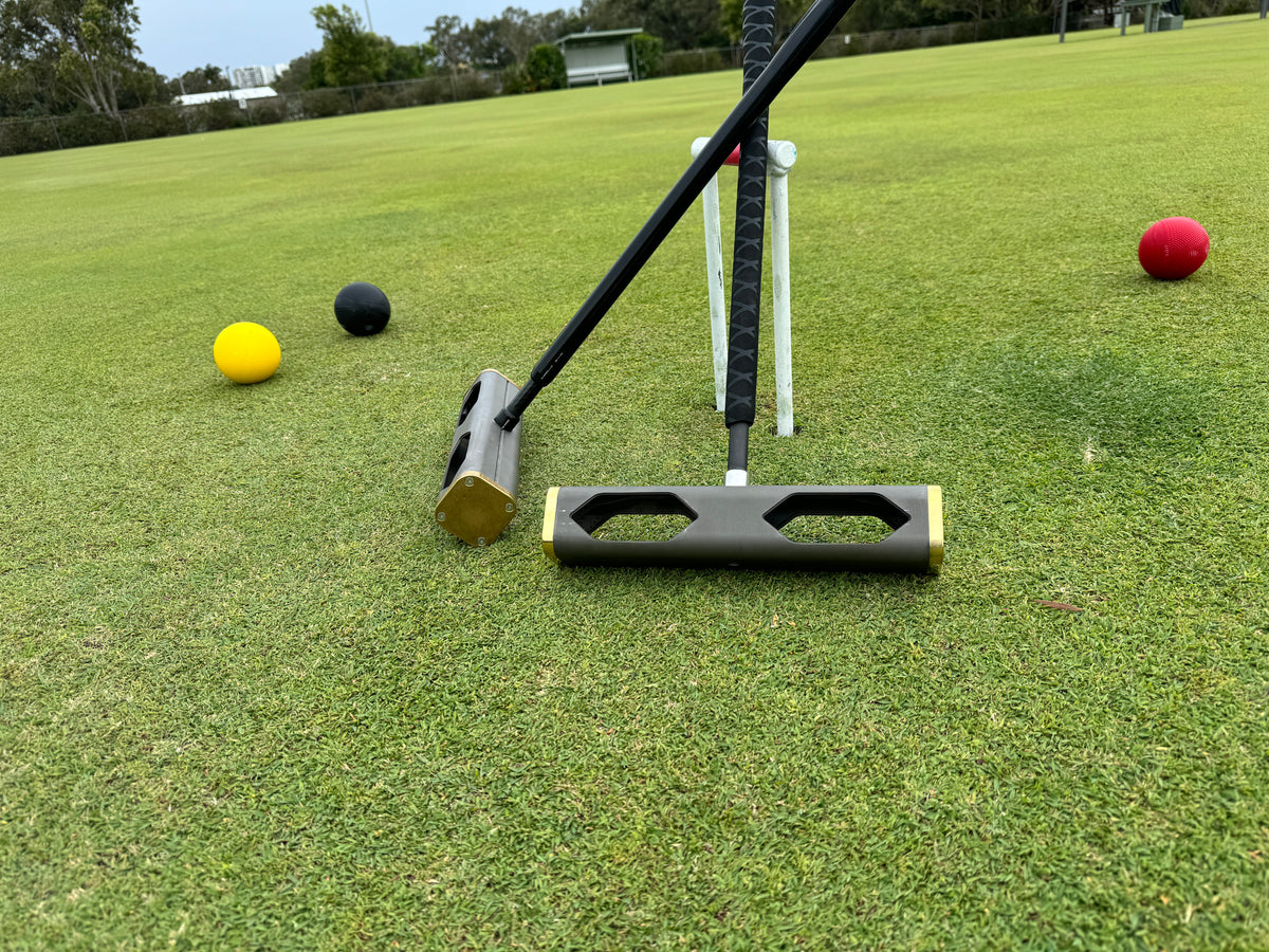 Invictus croquet mallet in use on a lawn